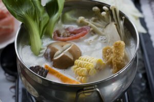 A creamy hotpot of veggies including sweet corn