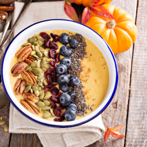 Smoothie bowl with pepitas and assorted fruits and nuts.